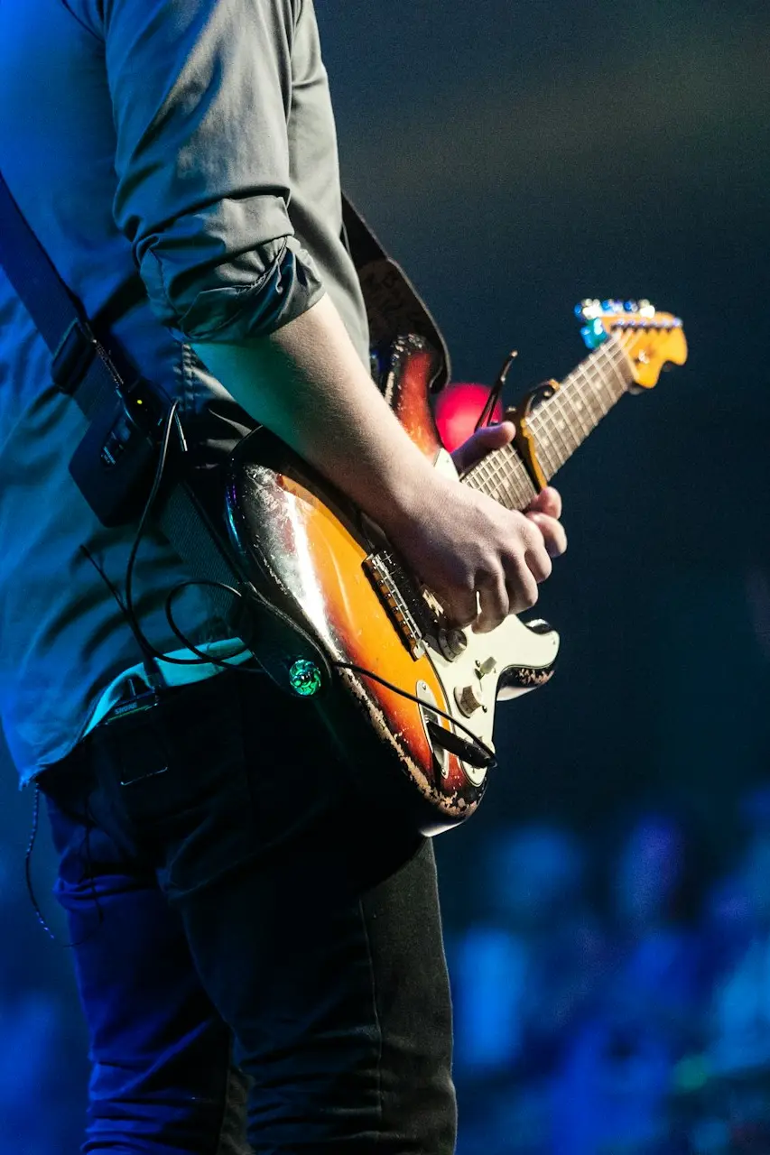 selective focus photography of man playing electric guitar on stage